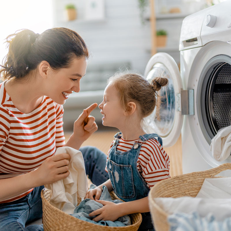 mother and daughter doing laundry
